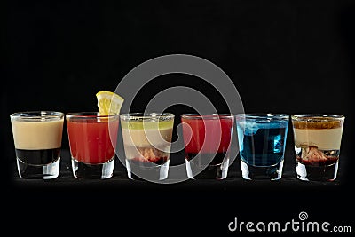 Mix alcoholic cocktail shots together with isolated black background Stock Photo