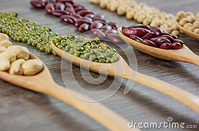 Various beans on wooden table Stock Photo