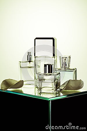 various bottles with perfumes on glass table Stock Photo