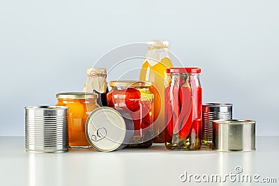 Various canned vegetables, meat, fish and fruits in tin and glass cans. Stock Photo