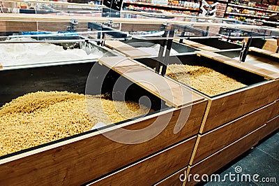 Various cereals and pasta at boxes on supermarket Stock Photo