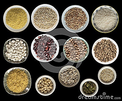 Various cereals, seeds, beans, peas on plates isolated on black background, top view. Stock Photo