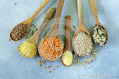 Various cereals in wooden spoons Stock Photo