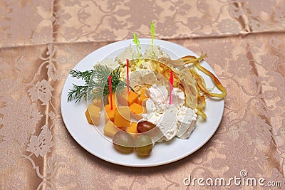 Various cheeses with greens and grapes white plates, closeup Stock Photo
