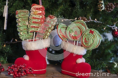 Various Christmas sweets and candies with christmas tree on wood table Stock Photo