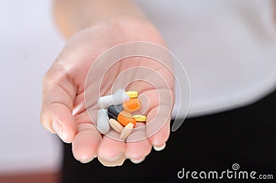 Various colored capsules placed in the hand Health care concept, capsule therapy, pharmaceutical industry, pharmacy Stock Photo