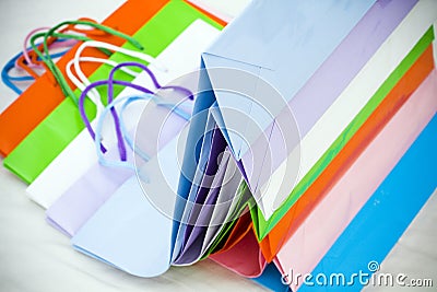 Various colorful empty gift paper bags stacked Stock Photo