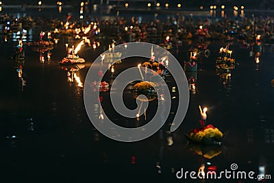 Various colorful Krathong floating with candles in lake in Benjasiri park in Bangkok Editorial Stock Photo