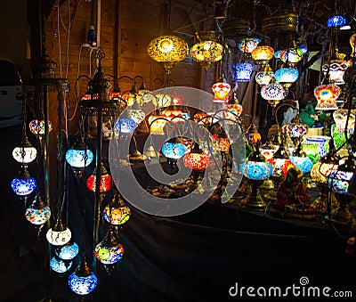 Various colorful round shaped retro glass lamps in darkness, in the market, as vintage color effect Editorial Stock Photo