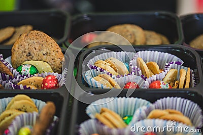 Various colourful biscuits in paper and trays, crunchy dessert for children Stock Photo