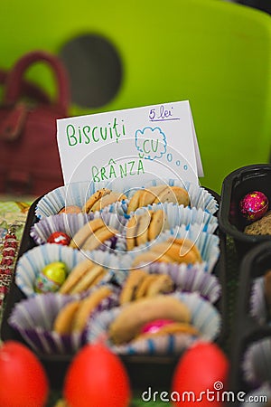 Various colourful biscuits in paper and trays, handwritten tag by kids, Romanian Stock Photo