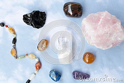 Various crystals or raw gemstone minerals with light blue background. Stock Photo