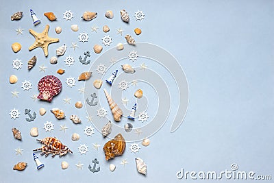 Various decorative nautical items, seashells, sea stars and miniature toys on blue pastel background. Sea travel, summer vacation Stock Photo