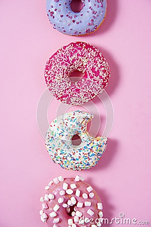 Various donuts line on a pink background. Stock Photo