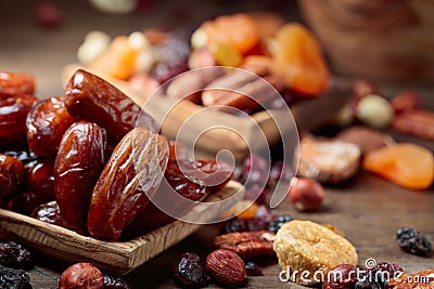 Various dried fruits and nuts in wooden dish Stock Photo