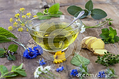 Various dried meadow herbs and herbal tea on old wooden table. fresh medicinal plants and in bundle. Preparing medicinal Stock Photo
