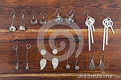 Various earrings over wooden background Stock Photo