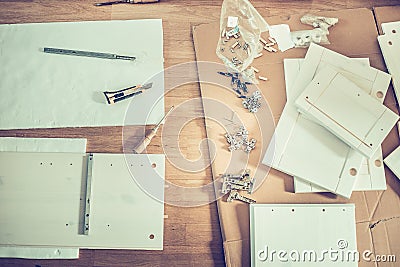 Various furniture assembly parts and tools assembly laid out on the floor Stock Photo