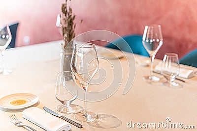 Various glasses and cutlery ready to use in a hotel. Stock Photo