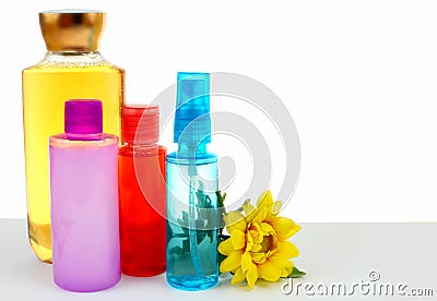 Various hair and body beauty products in bright colors with a cheerful yellow chrysanthemum Stock Photo