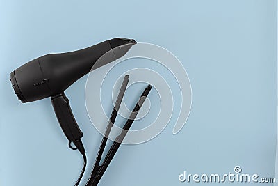 Various hair styling devices on blue paper background, top view Stock Photo