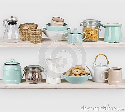 Various kitchen utensils and food ingredients isolated on wooden shelves Stock Photo