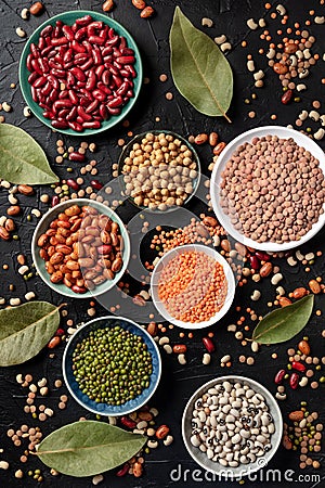 Various legumes, shot from the top on a dark background. Lentils, soybeans, chickpeas, red kidney beans, black-eyed peas and other Stock Photo