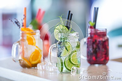 Various lemonades in mason jars with orange lime lemon otange st Stock Photo