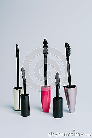 Various mascara brushes on a blue pastel background. The concept of choosing makeup products Stock Photo