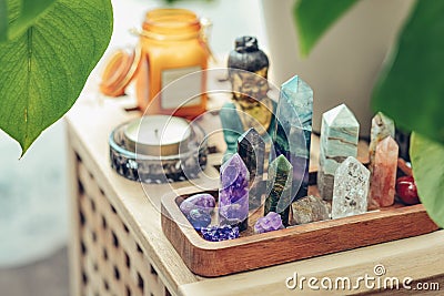 Various minerals and healing crystals on a wooden tray Stock Photo