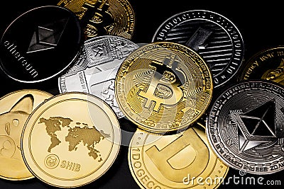 Various physical metal coins scattered over black background. Cryptocurrency concepts Stock Photo