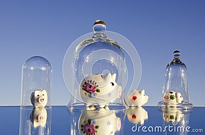 Various piggy-banks on mirror Stock Photo