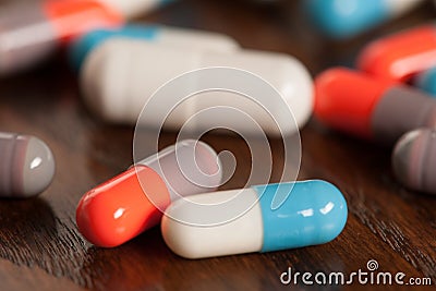 Various pills on wooden table - antibiotics Stock Photo