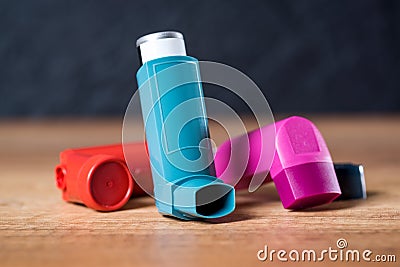 Asthma inhalers on a wooden table Stock Photo