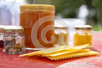 Various products such as propolis, honey wax plates against blurred background Stock Photo