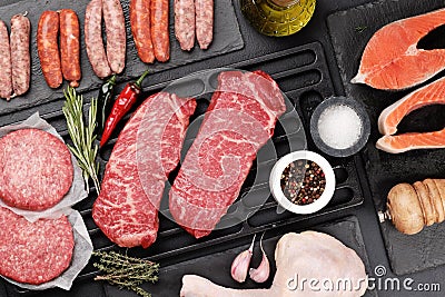 Various raw meat and fish. Steaks, sausages, salmon, chicken and spices Stock Photo