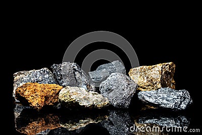 Various raw ore gemstones or rocks on black background, mining and geology Stock Photo