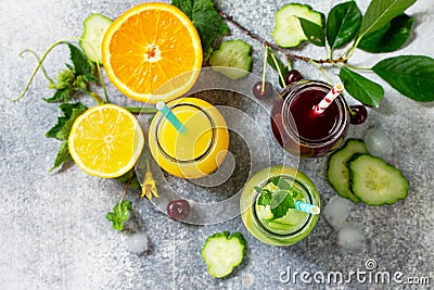 Various refreshments drinks - detox cucumber water, cherry juice and orange juice Stock Photo