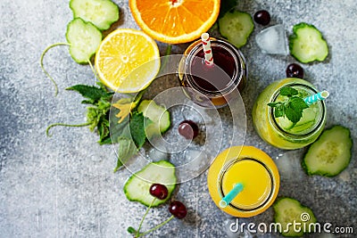 Various refreshments drinks - detox cucumber water, cherry juice and orange juice Stock Photo