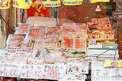 Various seafood display with snowflakes front of seafood shop in Arsaiji fresh market on snow day Editorial Stock Photo