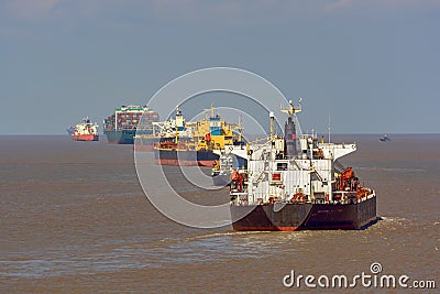 Various ships queue offshore approaching Shanghai. Stock Photo