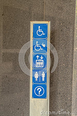 Various signages on a metal plate against the exterior wall of building Stock Photo