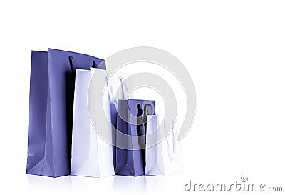 Various sizes of holiday shopping gift bags color very peri lavender on isolated white background Stock Photo