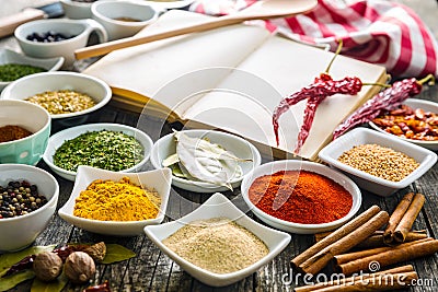 Various spices and blank cookbook. Stock Photo