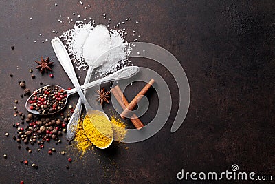 Various spices spoons on stone table Stock Photo