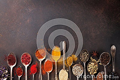 Various spices spoons on stone table Stock Photo