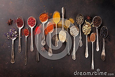 Various spices spoons on stone table Stock Photo