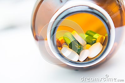 Various tablets pills in bottle Stock Photo