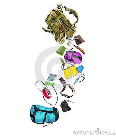 Various travel accessories falling from military backpack isolated on white background Stock Photo