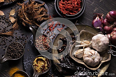 Various type of oriental earthy flavor dry spices on dark wooden table such as turmeric, black pepper, chili flake, bay leaf, for Stock Photo